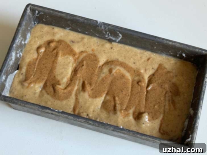 Dessert Person Banana bread batter in the pan with the almond butter swirl on top