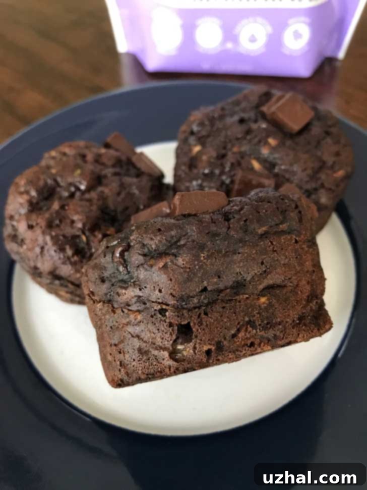 Low sugar chocolate zucchini muffins made with Splenda Magic Baker, an allulose blend, showcasing a moist and rich texture.