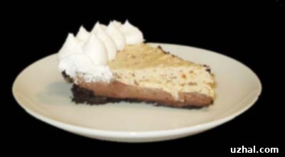A slice of Chocolate Butterfinger Pie with a creamy chocolate layer and a lighter Butterfinger topping.
