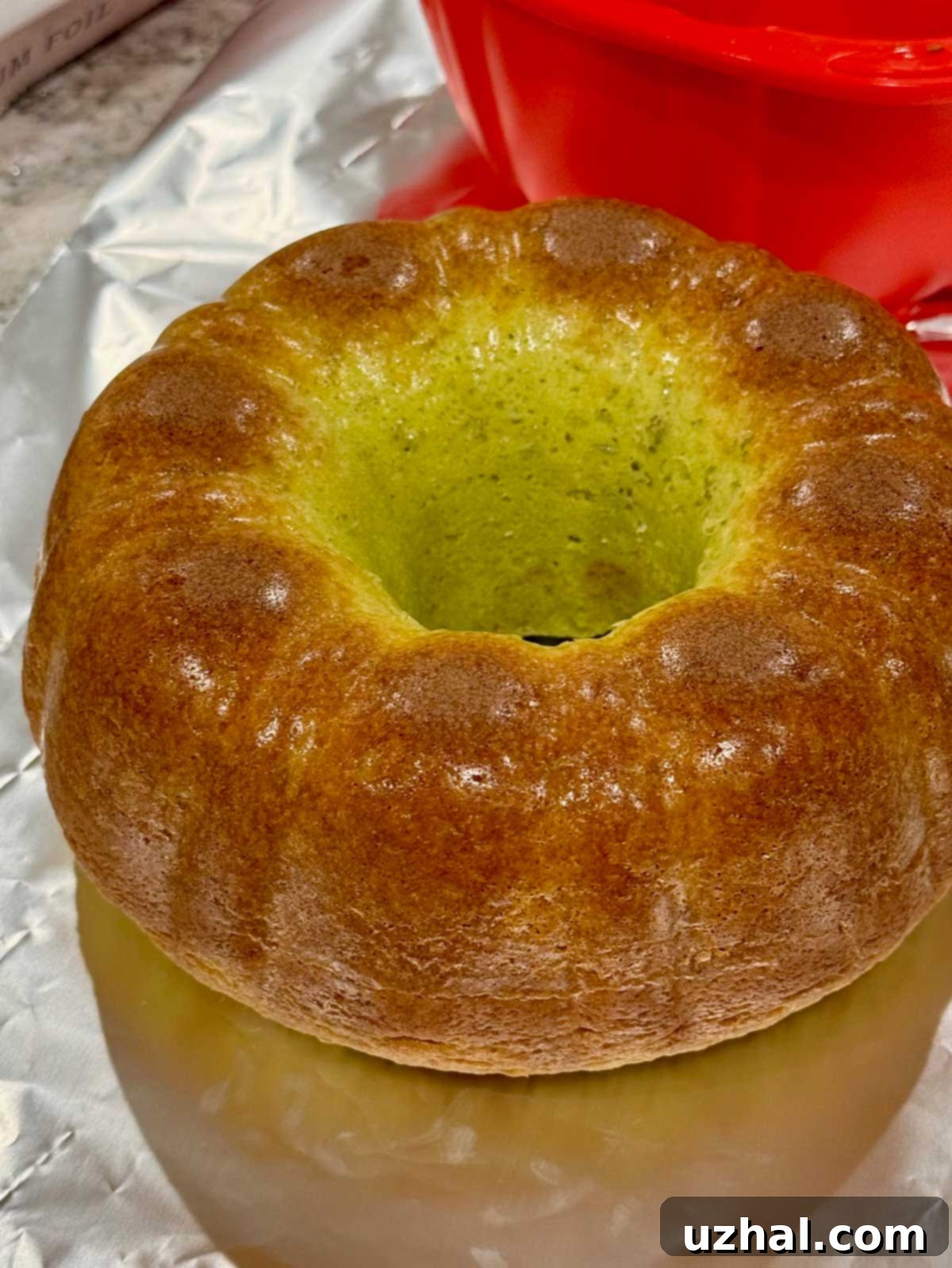 Midori Melon Bundt 5 A shiny, perfectly released Bundt cake that just came out of a silicone pan, showcasing its smooth texture.
