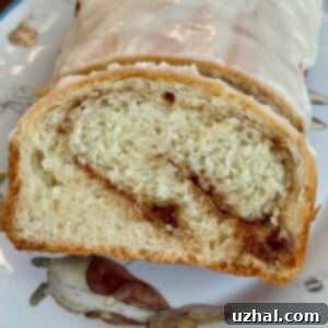 A delicious slice of homemade cinnamon swirl bread, perfect for breakfast or a sweet snack, reminiscent of school lunchroom treats.