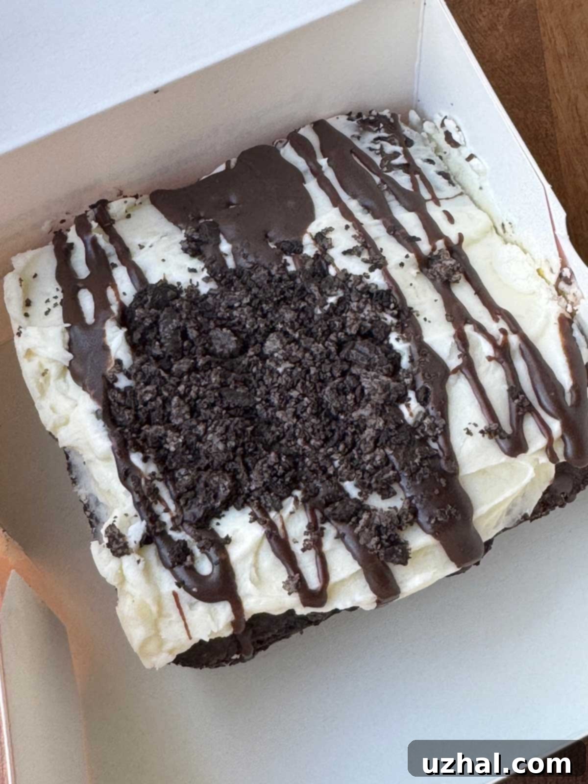An actual Crumbl Oreo brownie in a box, showcasing its appealing texture and topping.