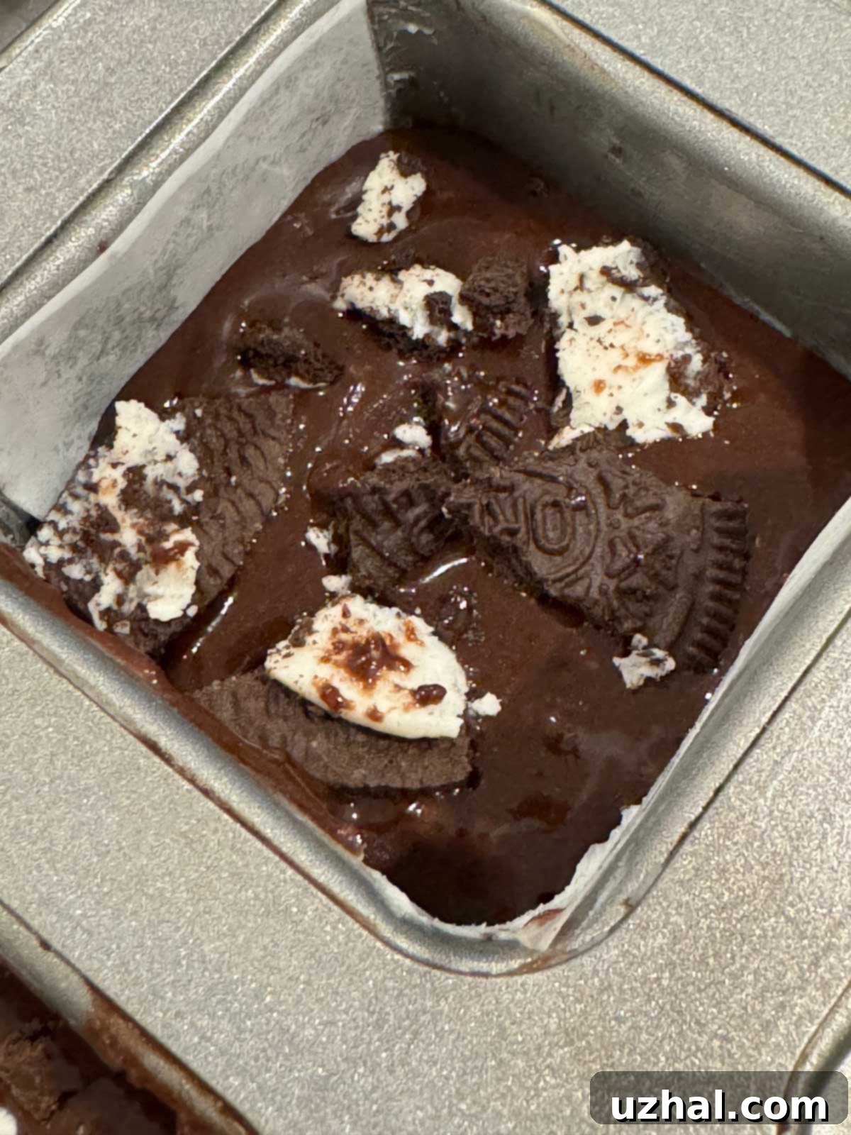Crumble Brownies Copycat batter in a square muffin pan, ready for baking.