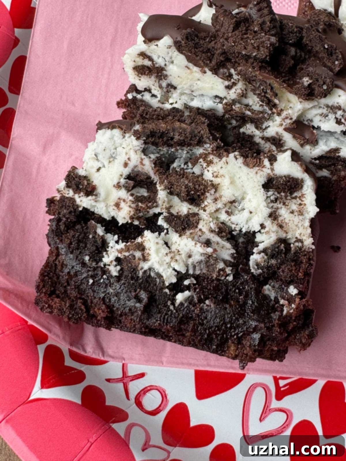 Crumble Oreo Brownie Copycat split in half to show the texture of the cream cheese frosting and brownie inside.