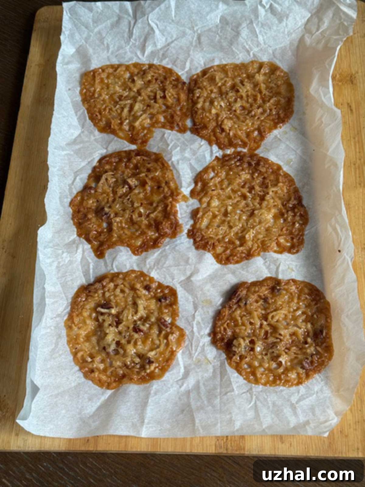 Lady Bird Johnson's Signature Lace Cookies 3 Lady Bird Johnson's Lace Cookies cooling on a sheet of parchment paper.