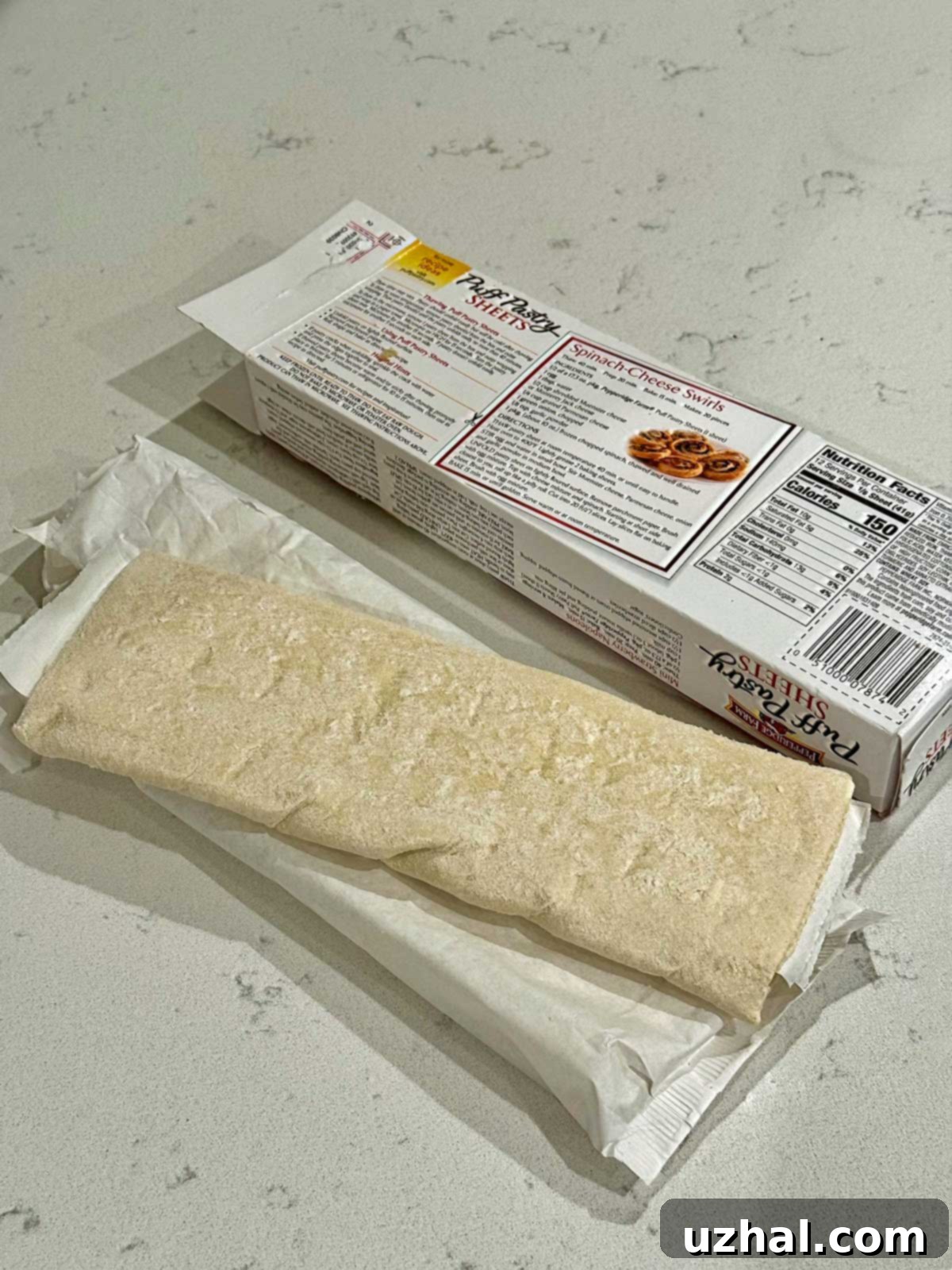 Golden Sweet Apple Pockets 3 Puff pastry dough being prepared for apple hand pies, showing rectangular cuts and gentle stretching.
