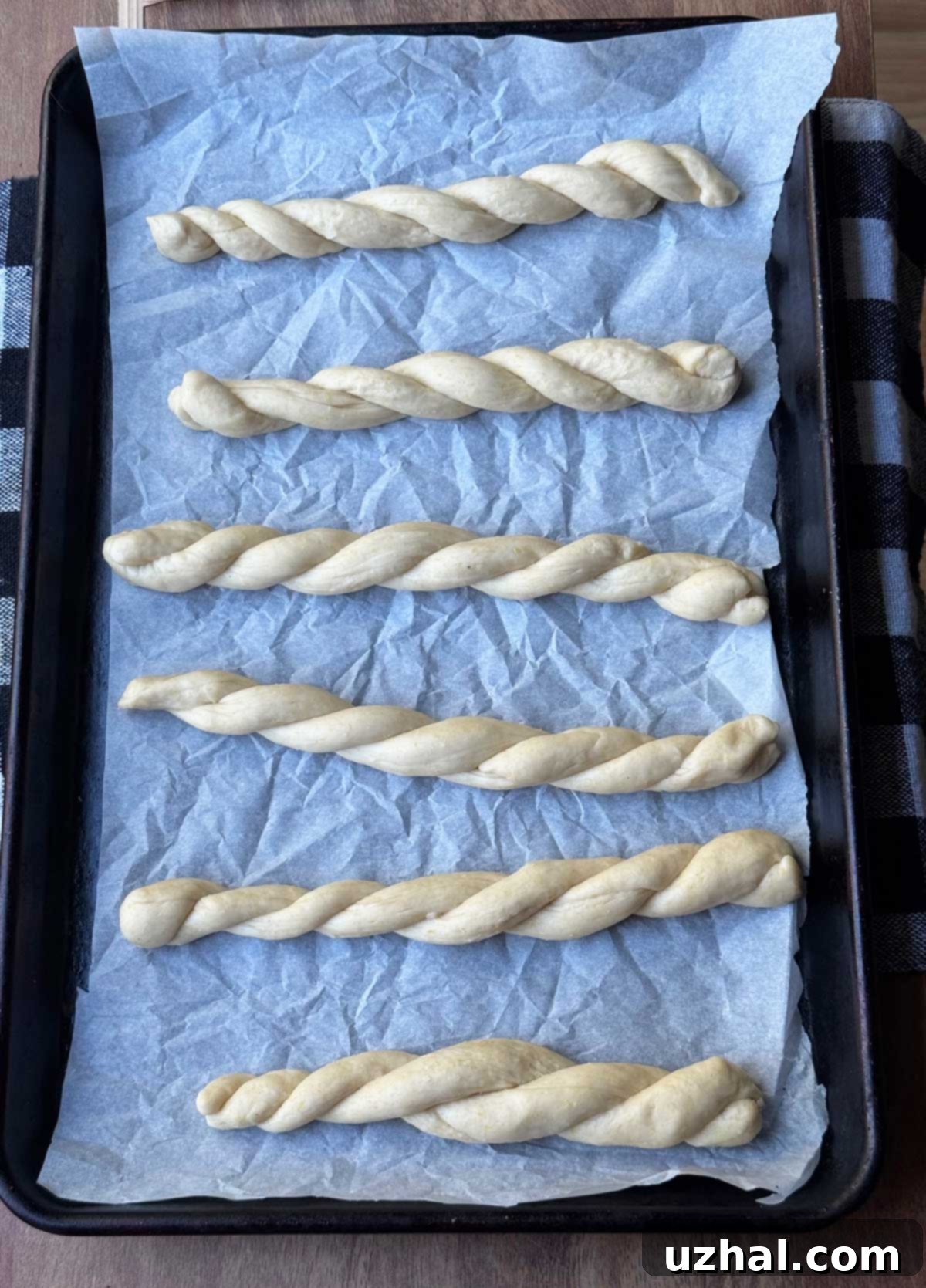 Close-up of dough being kneaded in a stand mixer.