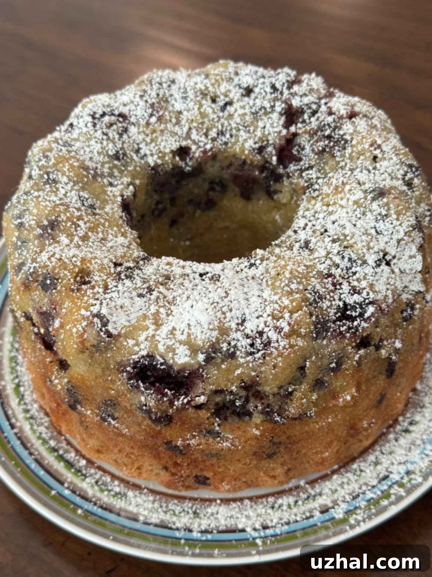 Morning Bliss: Gluten-Free Berry Cherry Coffee Cake 2 Gluten-Free Coffee Cake baked in a Bundt pan, beautifully golden brown and dusted with powdered sugar, ready for serving.