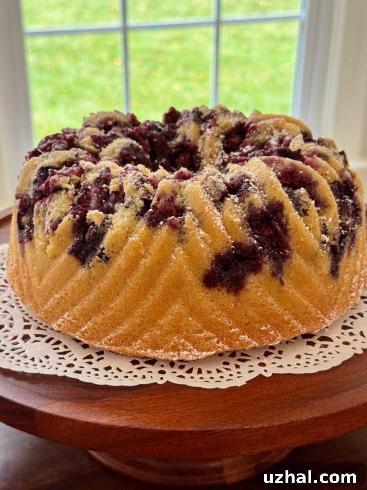 Morning Bliss: Gluten-Free Berry Cherry Coffee Cake 3 Gluten-Free Bundt cake with a slightly 'cobbler-topped' appearance due to blueberries sinking, still delicious with powdered sugar.