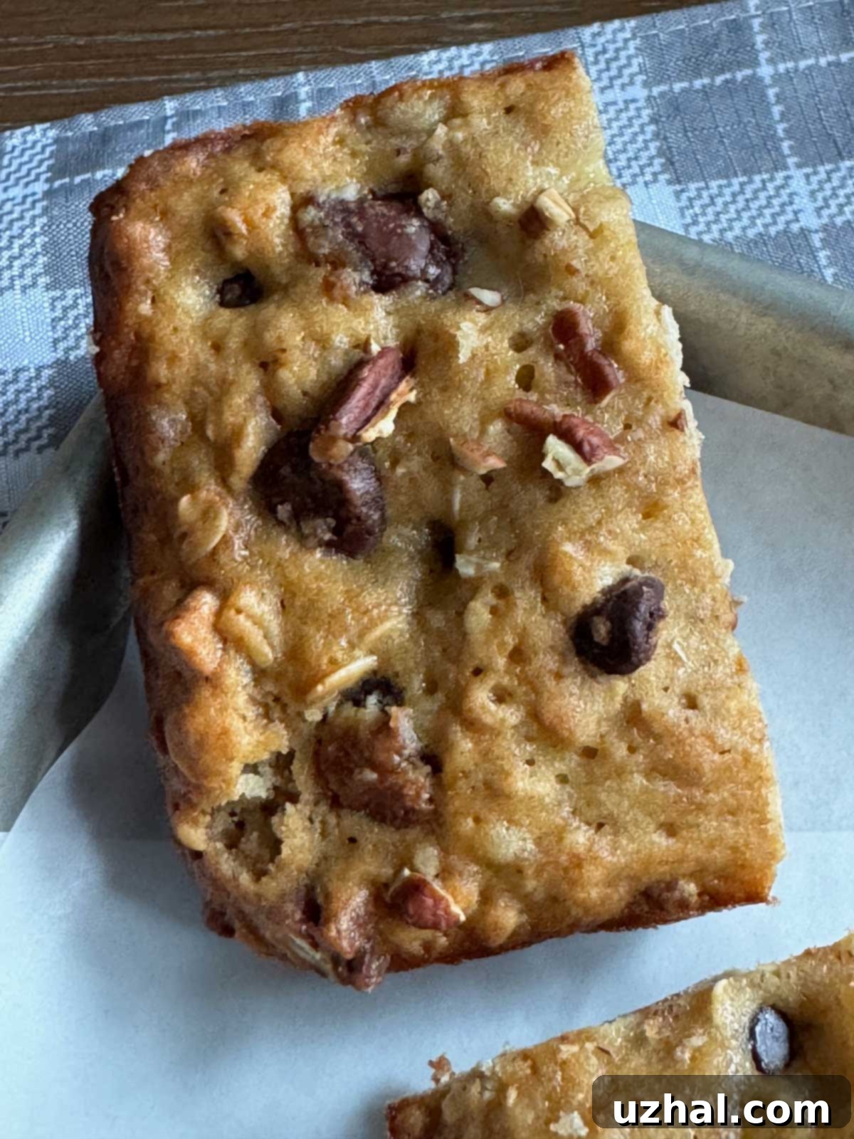 Decadent Brown Butter Banana Chocolate Chip Bars 3 Brown Butter Banana Chocolate Chip Bars recipe baked in a loaf pan, showing a rich, golden crust and thick slices.