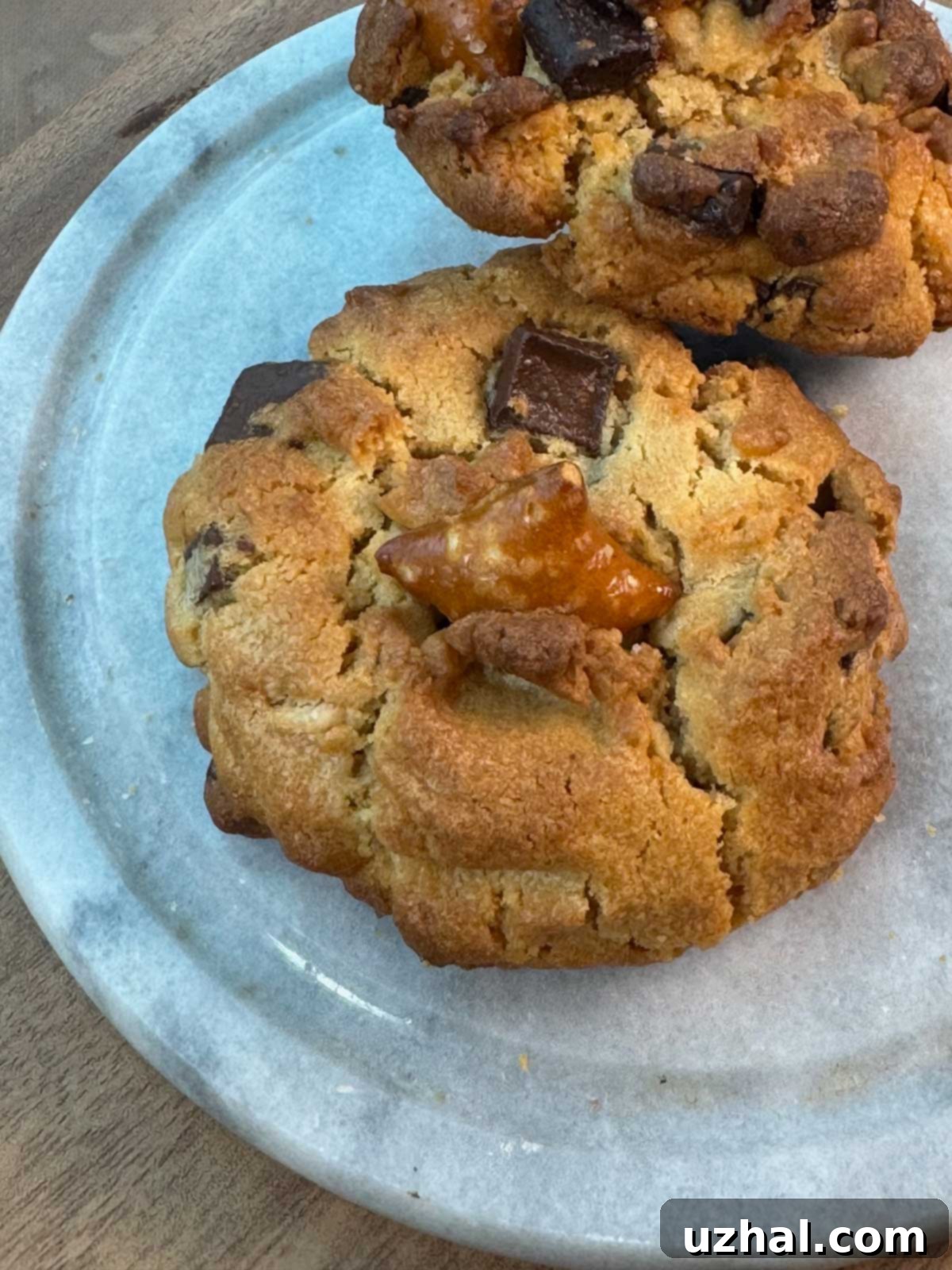 Giant Peanut Butter Pretzel Chocolate Chip Cookies 4 Giant Peanut Butter Chocolate Chunk Pretzel Cookies on a plate.