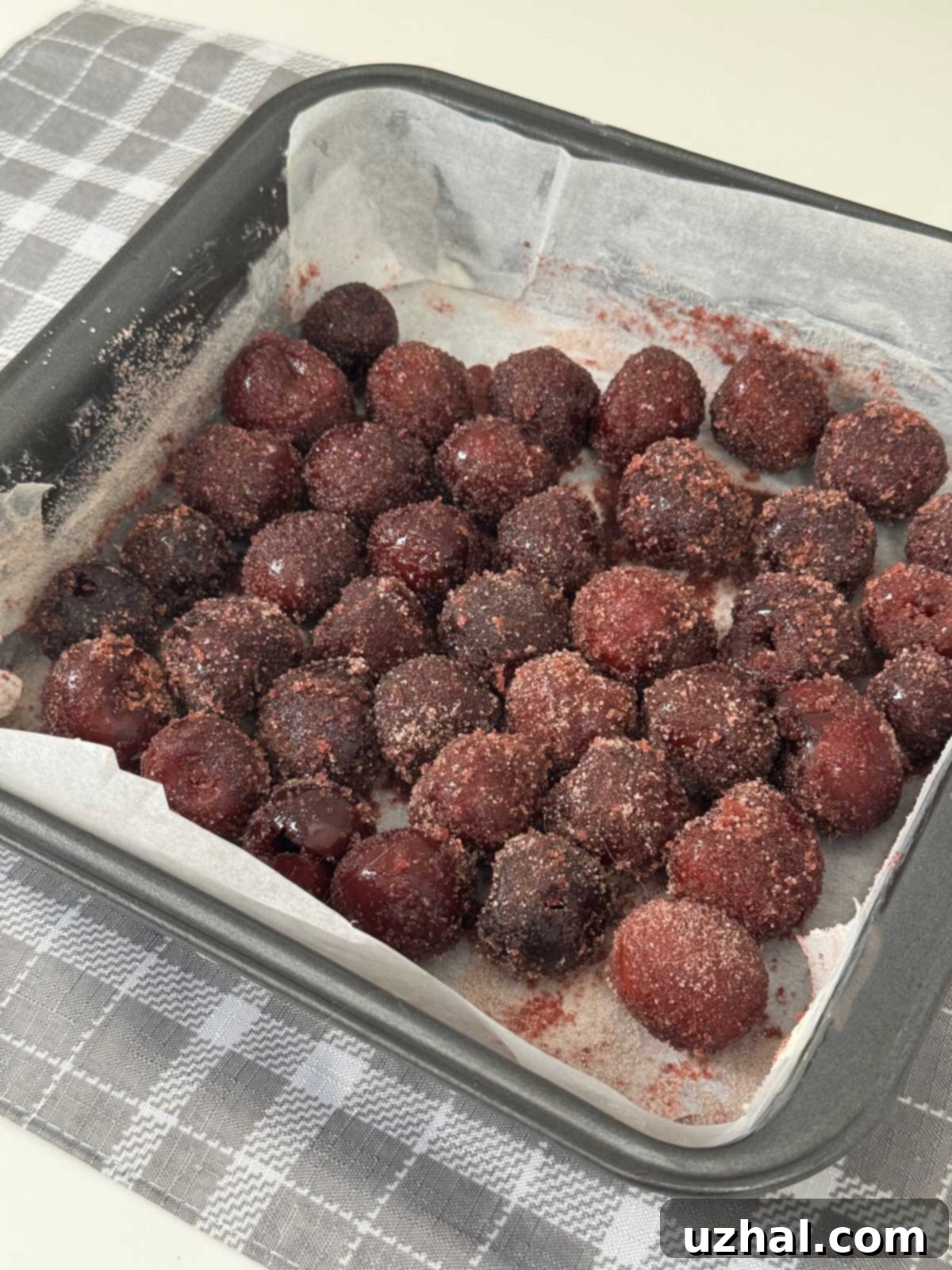 Frozen cherries in an 8-inch square pan to be made into a Cha-Cha-Cha Cherry Cake.