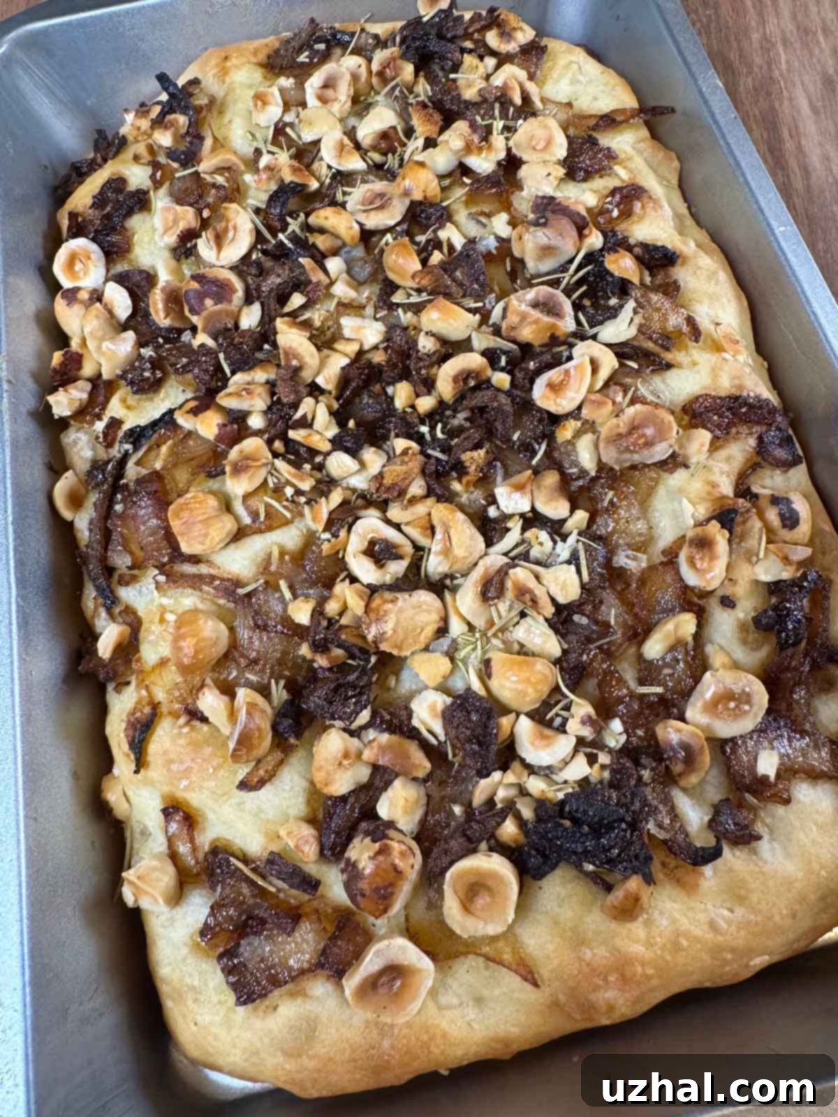 Focaccia topped with hazelnuts and caramelized onions.