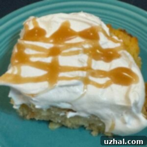 Menehune Bread Pudding topped with whipped cream and caramel sauce.